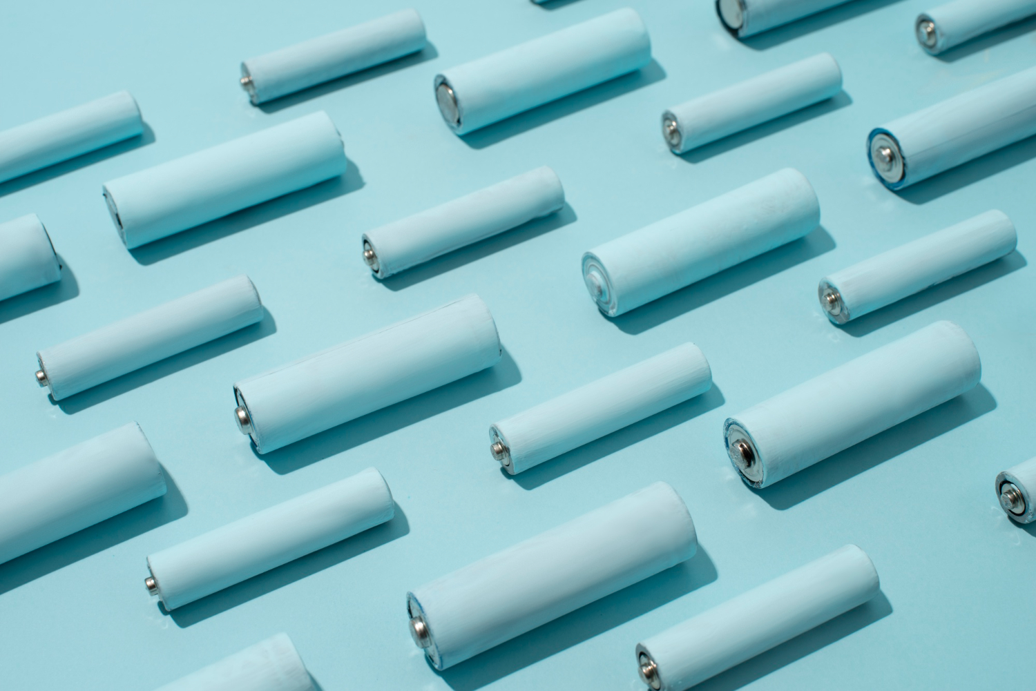 top view of batteries in rows on light blue surface